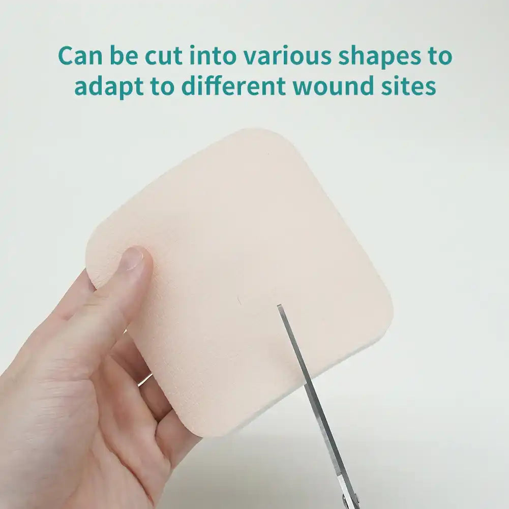 Hand cutting a medical foam wound dressing pad with scissors for customizable fit